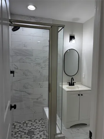 a bathroom with a sink a mirror and shower