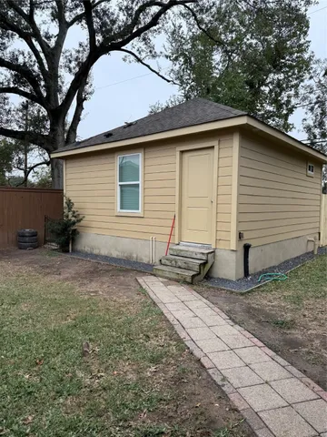 a backyard of a house with table and chairs