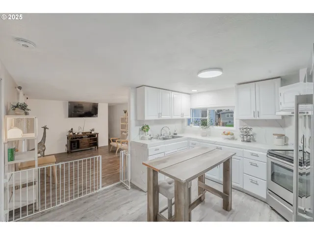 a kitchen with a table chairs refrigerator and cabinets