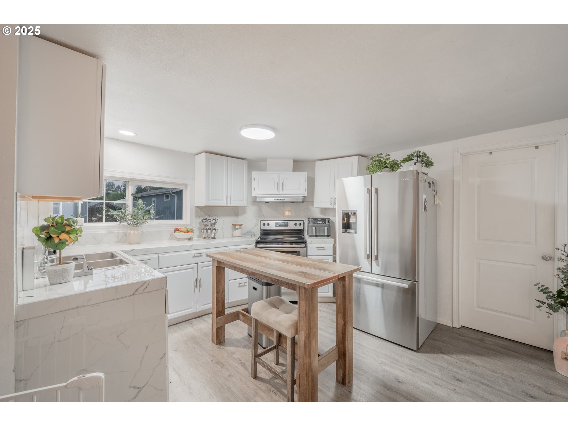 2012 Kennedy Circle Northeast, Unit 10 Keizer, OR 97303 - Photo 6 of 21 a kitchen with stainless steel appliances a refrigerator a sink a stove a dining table and chairs