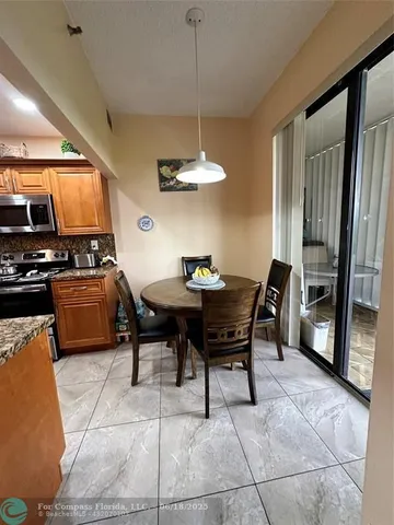 a kitchen with a table and chairs