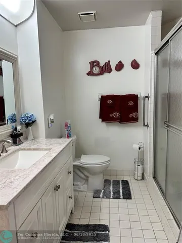 a bathroom with a sink toilet vanity and shower