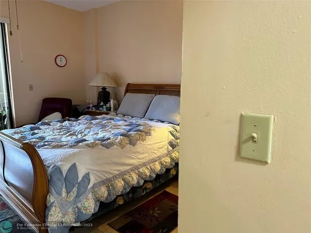 a bed sitting in a bedroom next to a bathroom sink