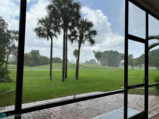 a view of a yard with potted plants