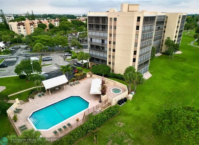 an aerial view of a house with a yard and lake view