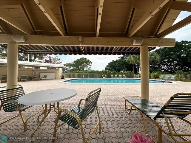 a view of a patio with a table chairs and backyard
