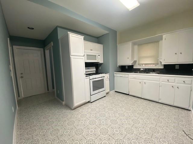 1715 East Pecan Street Sherman, TX 75090 - Photo 7 of 17 a kitchen with granite countertop a sink and white cabinets