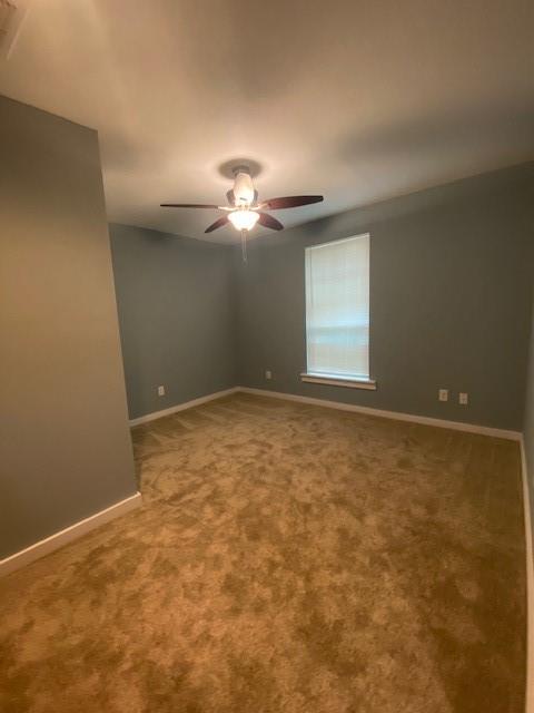 1715 East Pecan Street Sherman, TX 75090 - Photo 9 of 17 an empty room with a chandelier fan and windows