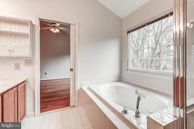 a bathroom with a tub and a window