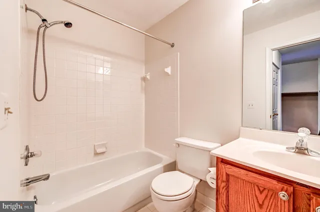 a bathroom with a sink toilet vanity and shower