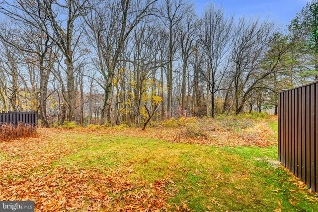 a view of yard covered with snow in front of house