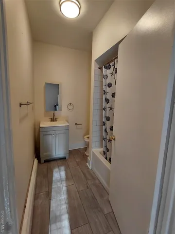 a view of a bathroom with sink a mirror and a shower