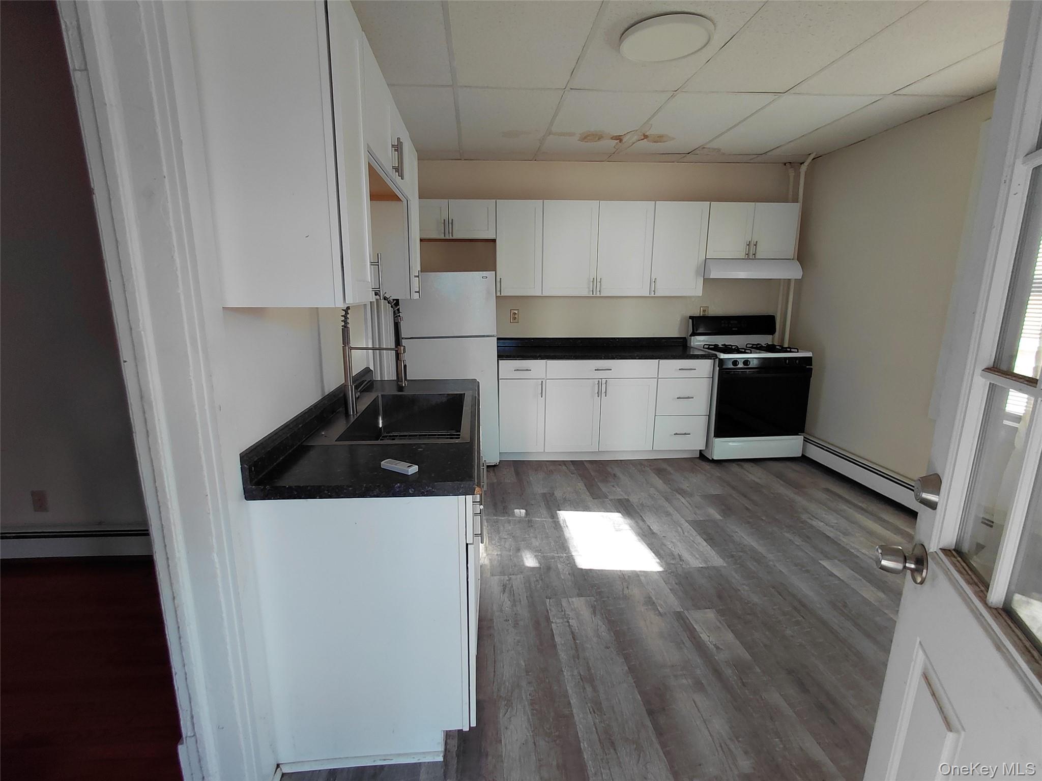 8 Center Street, Unit 1 Kingston, NY 12401 - Photo 2 of 13 a kitchen with a sink a stove and cabinets