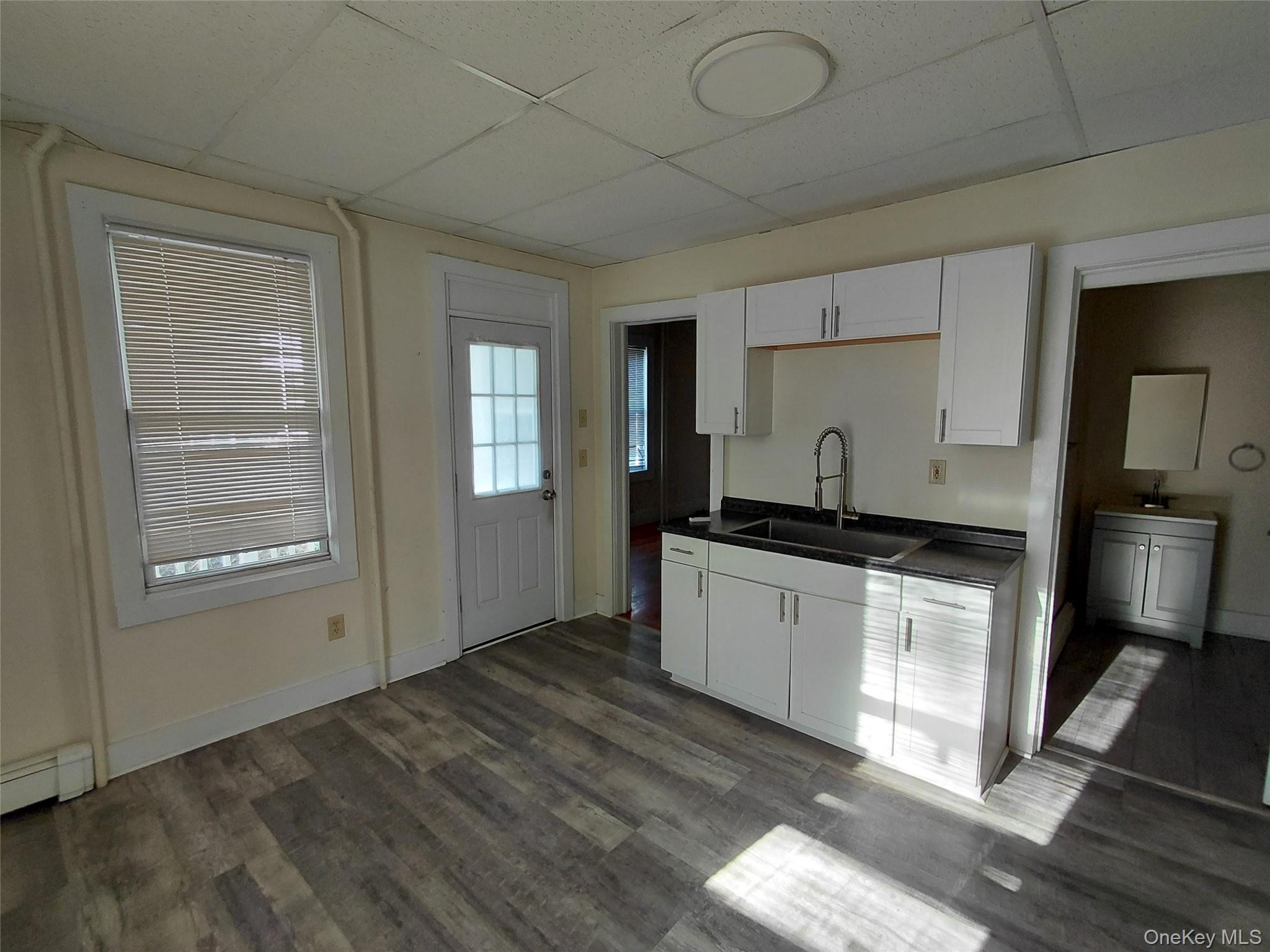 8 Center Street, Unit 1 Kingston, NY 12401 - Photo 3 of 13 a kitchen with granite countertop a stove a sink and a refrigerator