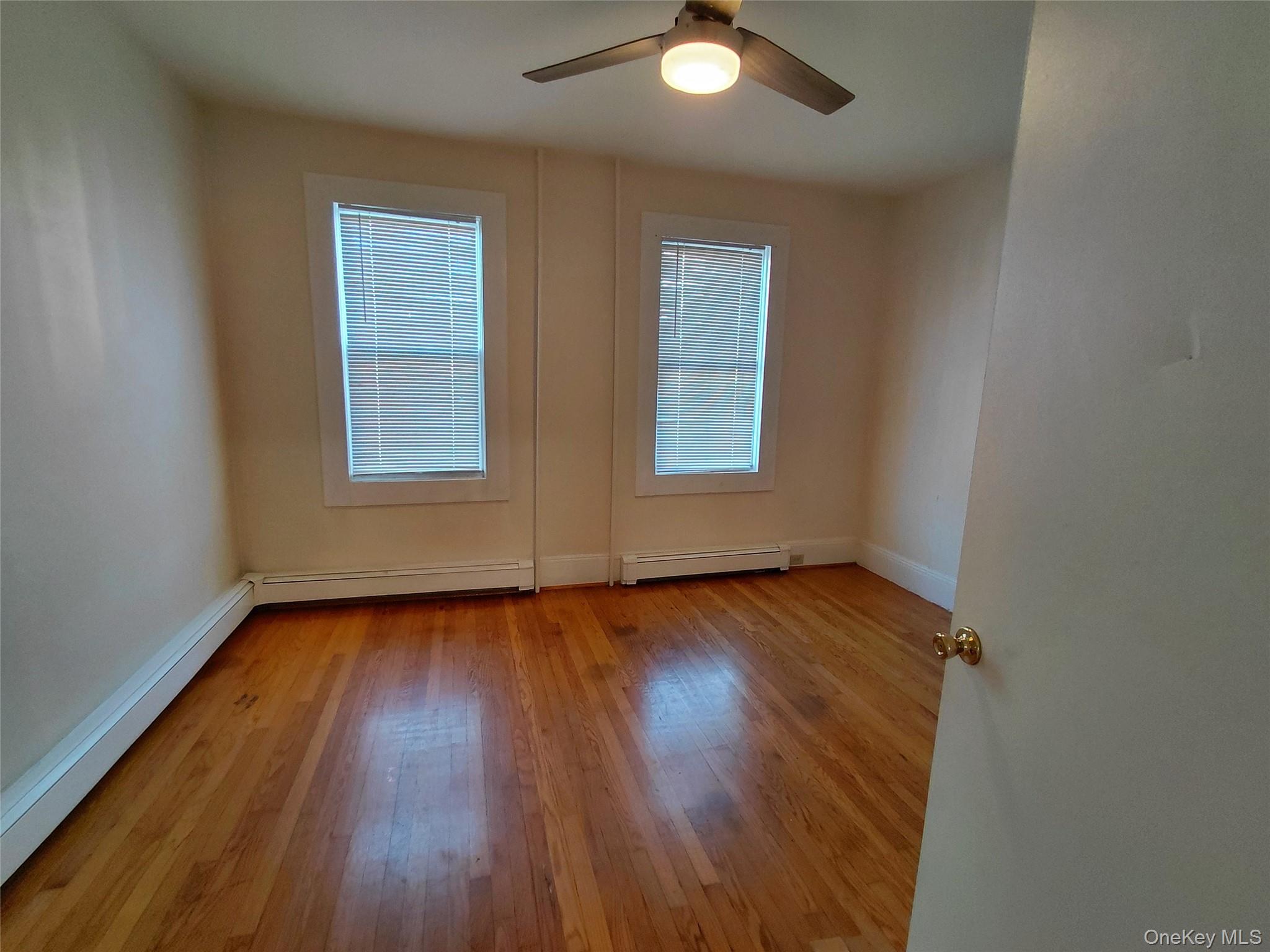 8 Center Street, Unit 1 Kingston, NY 12401 - Photo 6 of 13 an empty room with wooden floor and windows