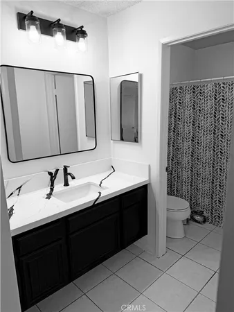 a bathroom with a double vanity sink and mirror