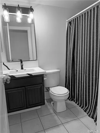a bathroom with a sink vanity and a toilet