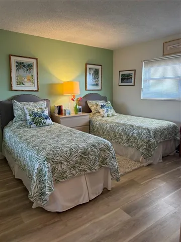 a bedroom with a bed and a painting on the wall