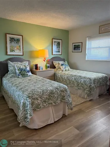 a bedroom with a bed and painting on the wall