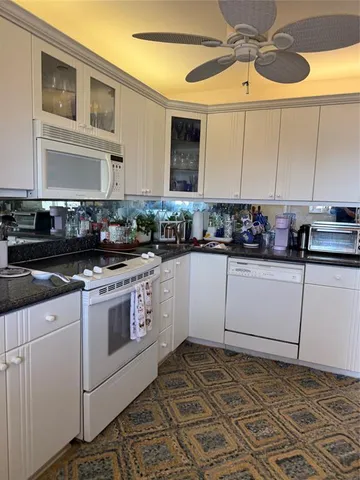 a kitchen with a stove cabinets and a sink
