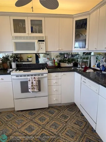 a kitchen with a stove and white cabinets