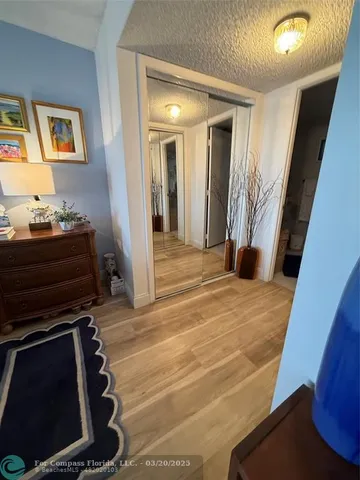 a room with gym equipment and wooden floor