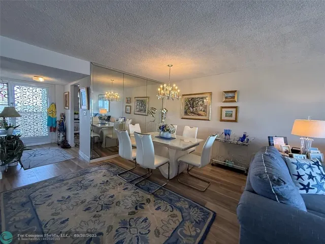 a living room with furniture and view of kitchen