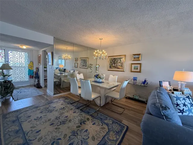 a living room with furniture and view of kitchen