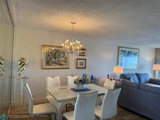 a view of a dining room with furniture and chandelier