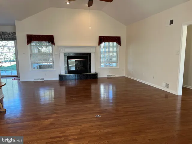 a kitchen with stainless steel appliances wooden floor sink and wooden cabinets