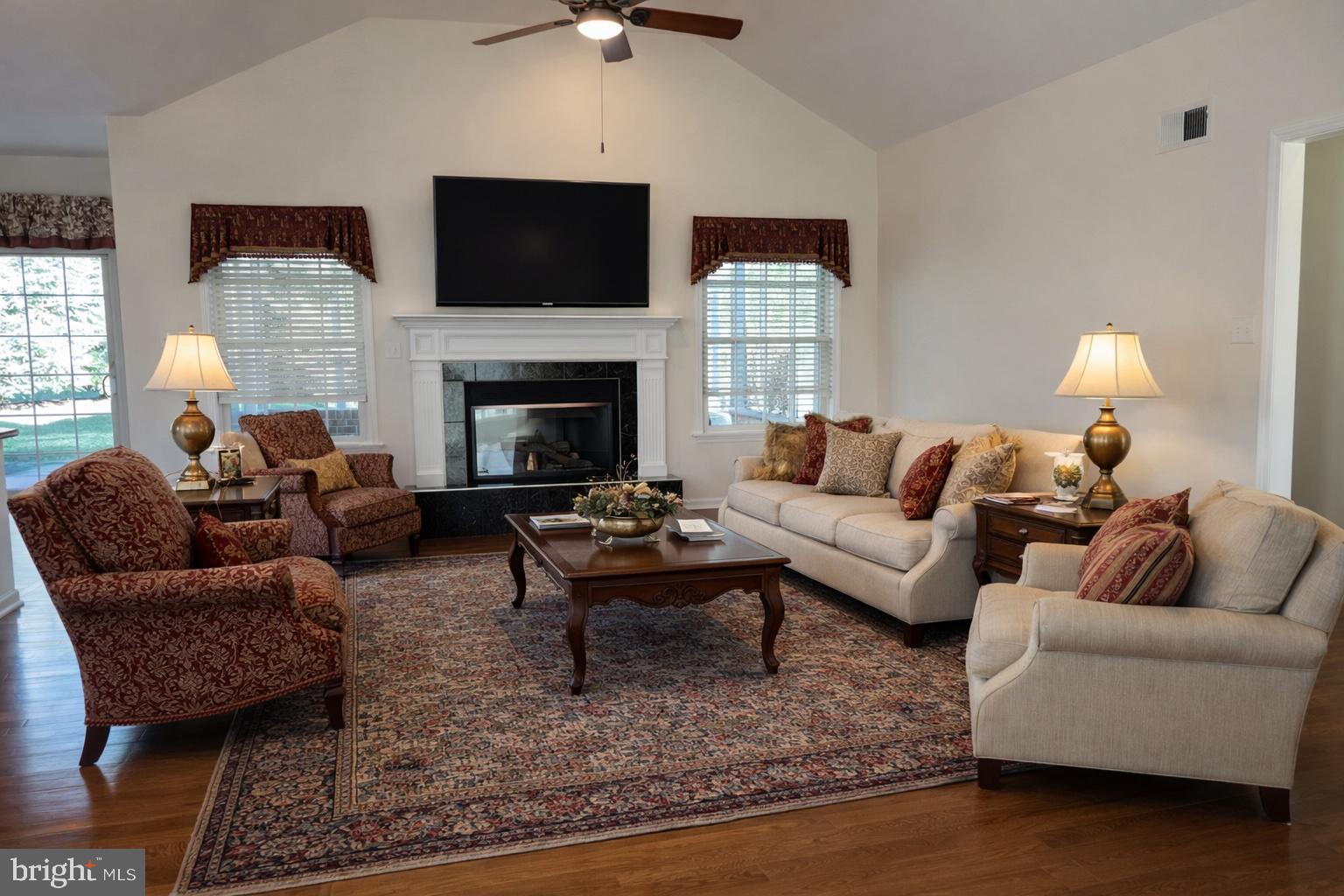 6337 Medina Ridge Drive Fayetteville, PA 17222 - Photo 14 of 50 a living room with furniture a flat screen tv and a fireplace