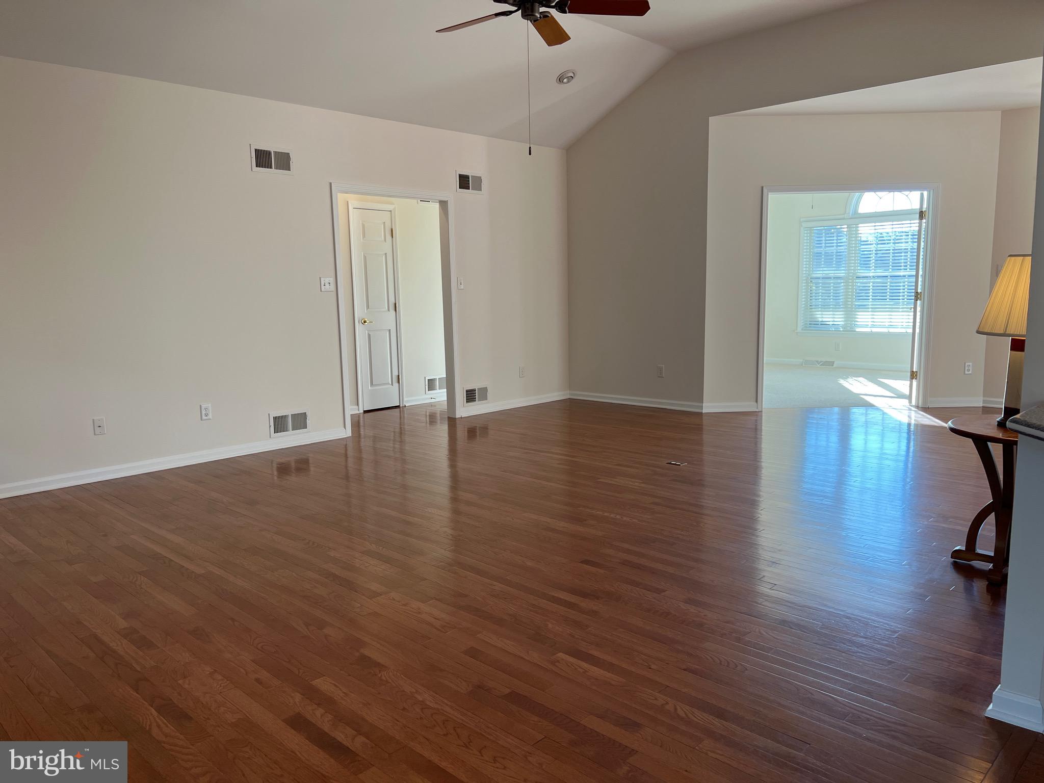 6337 Medina Ridge Drive Fayetteville, PA 17222 - Photo 15 of 50 an empty room with wooden floor and a hallway