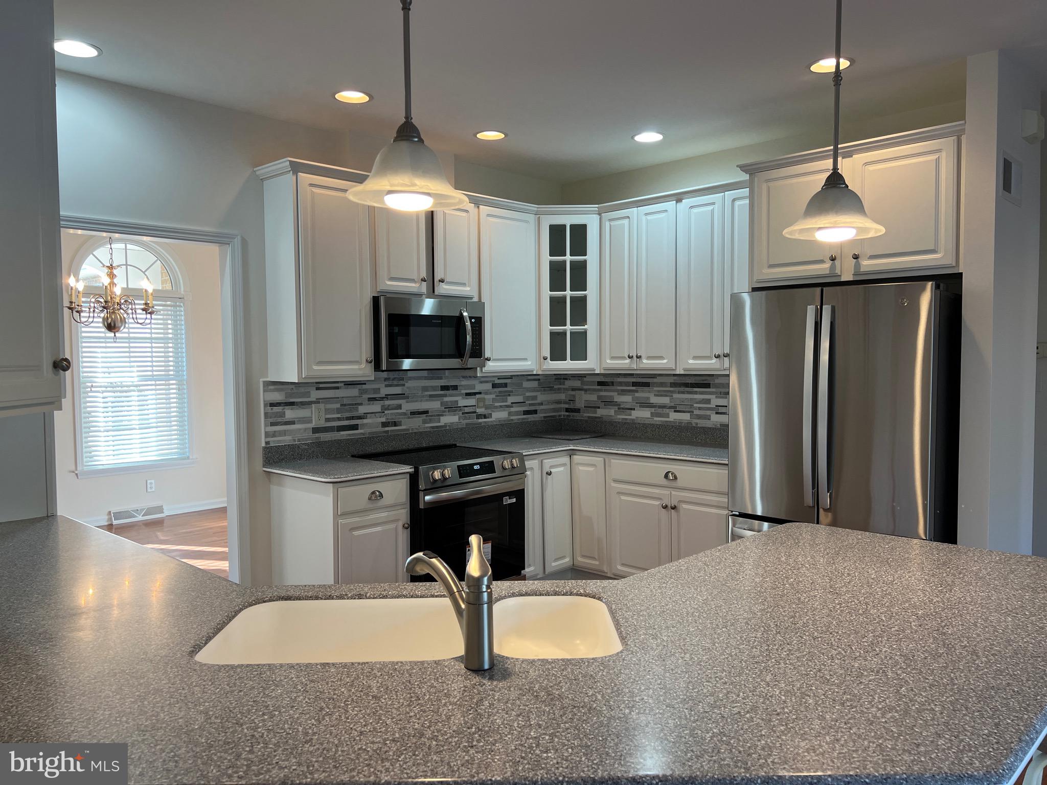 6337 Medina Ridge Drive Fayetteville, PA 17222 - Photo 21 of 50 a kitchen with stainless steel appliances granite countertop a sink refrigerator and microwave