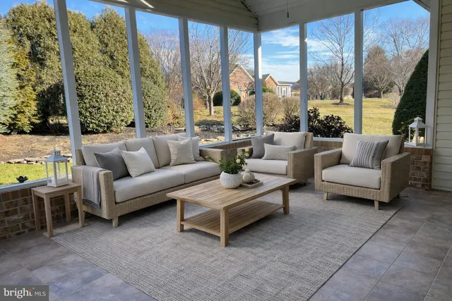 a view of a house with pool and sitting area