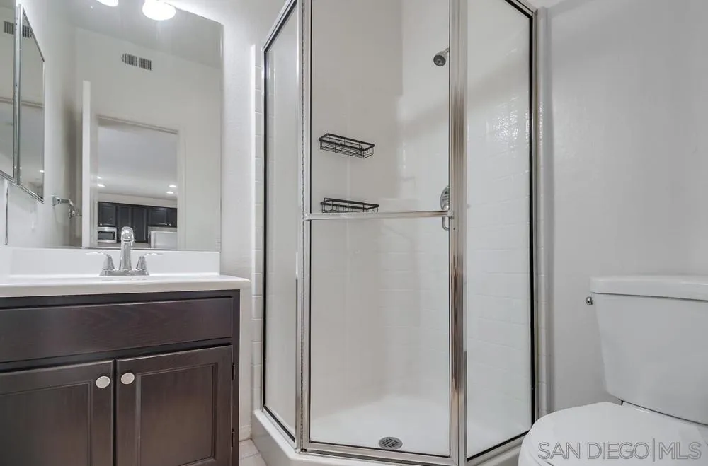 1298 Fools Gold Way, Unit 4 Chula Vista, CA 91913 - Photo 30 of 38 a bathroom with a sink mirror and toilet