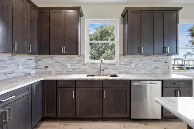 a kitchen with a sink cabinets and window