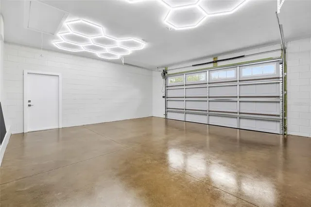 an empty room with windows and cabinet