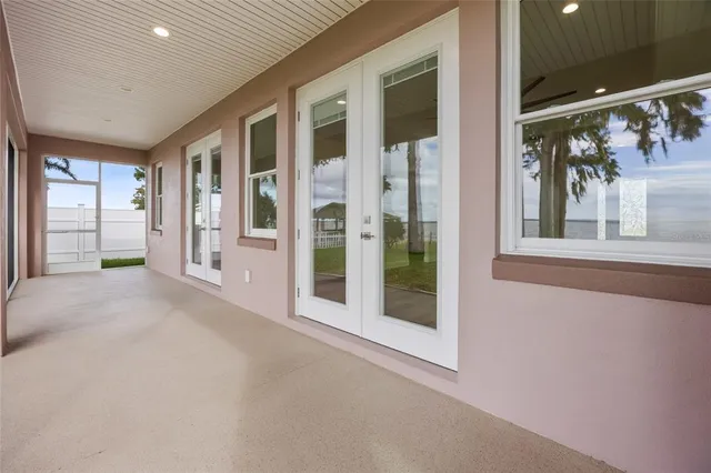 a view of a big room with windows and entryway