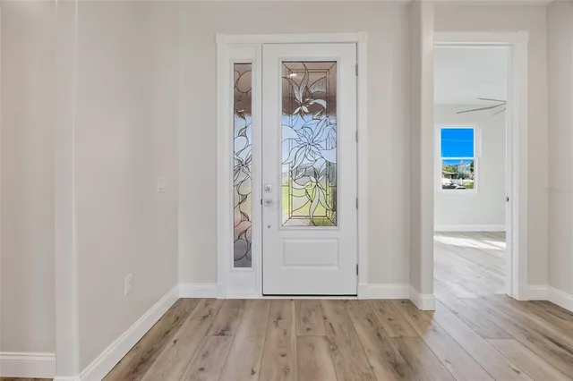 an empty room with window and wooden floor