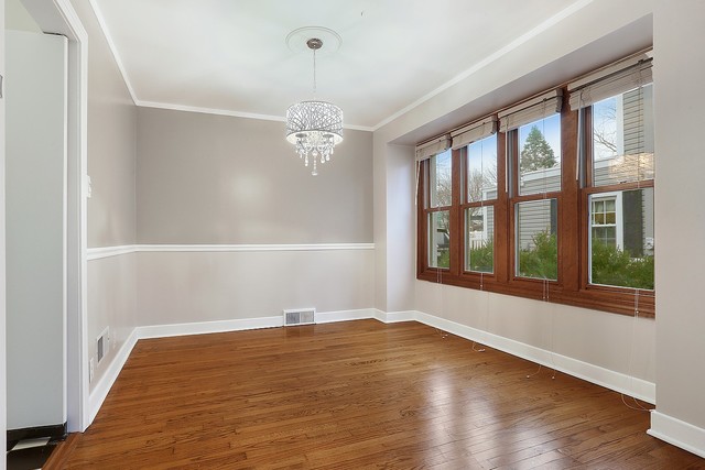 18427 Stewart Avenue Homewood, IL 60430 - Photo 3 of 13 a view of an empty room with wooden floor and a window