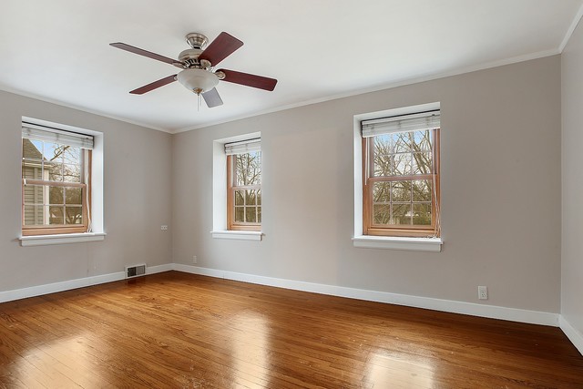 18427 Stewart Avenue Homewood, IL 60430 - Photo 7 of 13 a view of an empty room with wooden floor and a window