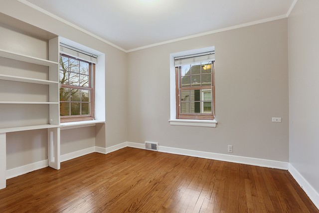 18427 Stewart Avenue Homewood, IL 60430 - Photo 9 of 13 a view of an empty room with wooden floor and a window