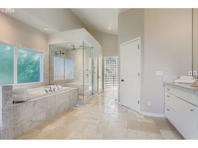 a bathroom with a granite countertop sink mirror and shower