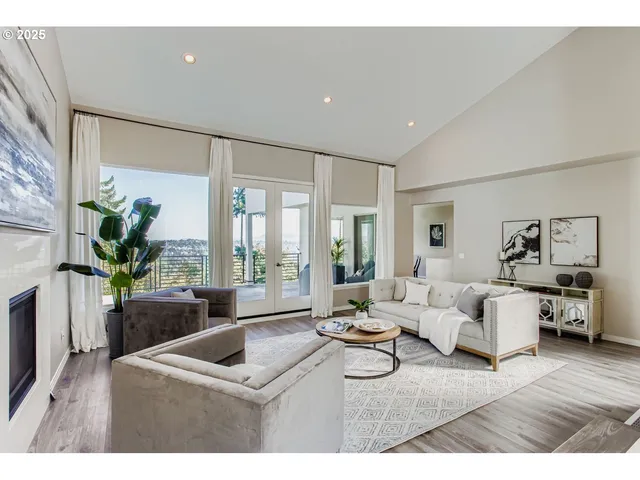 a living room with furniture potted plant and a large window