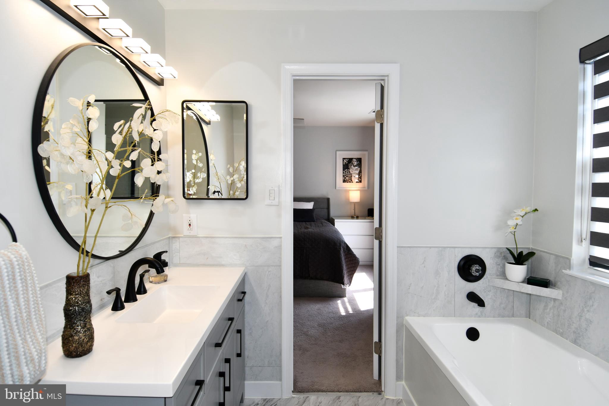 10188 Speedwell Court Manassas, VA 20110 - Photo 29 of 51 a bathroom with a tub sink and mirror