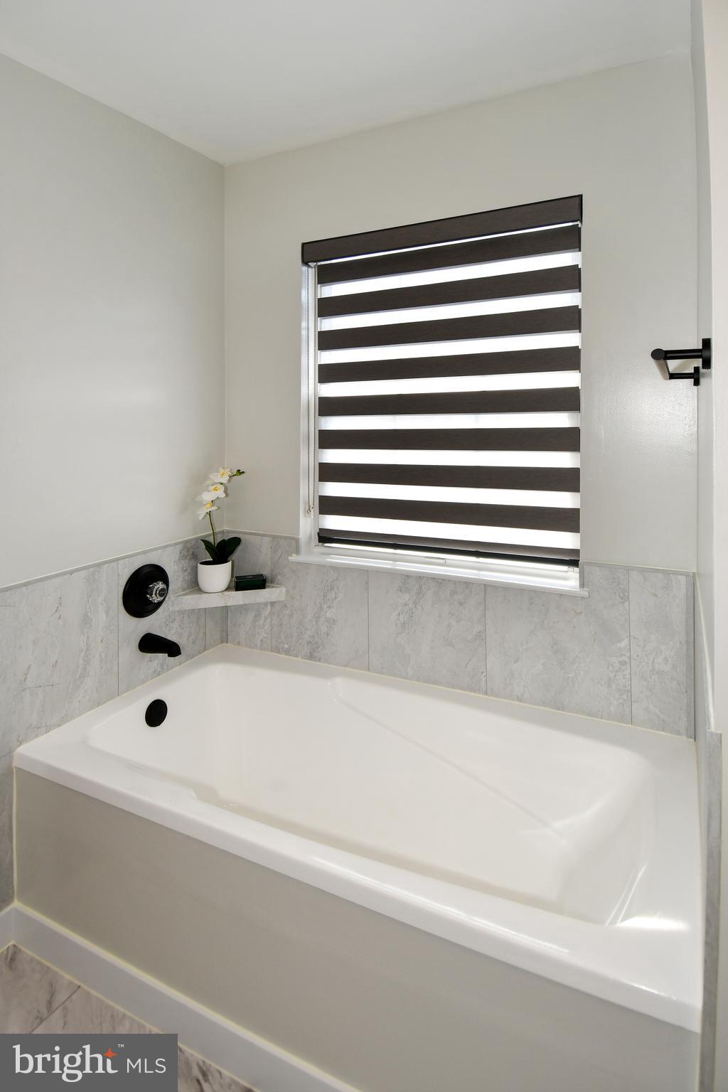 10188 Speedwell Court Manassas, VA 20110 - Photo 33 of 51 a bathroom with a bathtub and shower