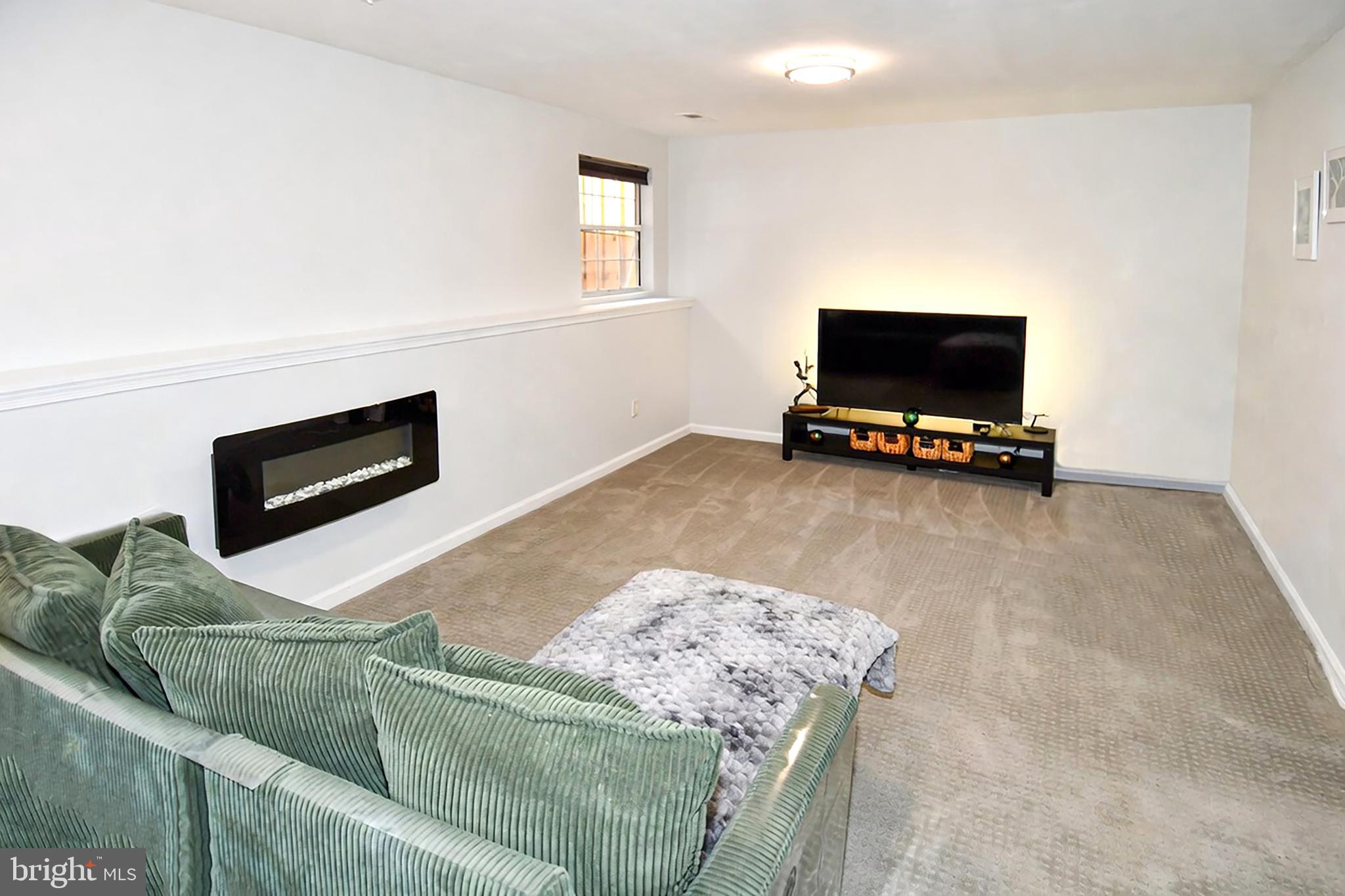 10188 Speedwell Court Manassas, VA 20110 - Photo 41 of 51 a living room with furniture and a flat screen tv
