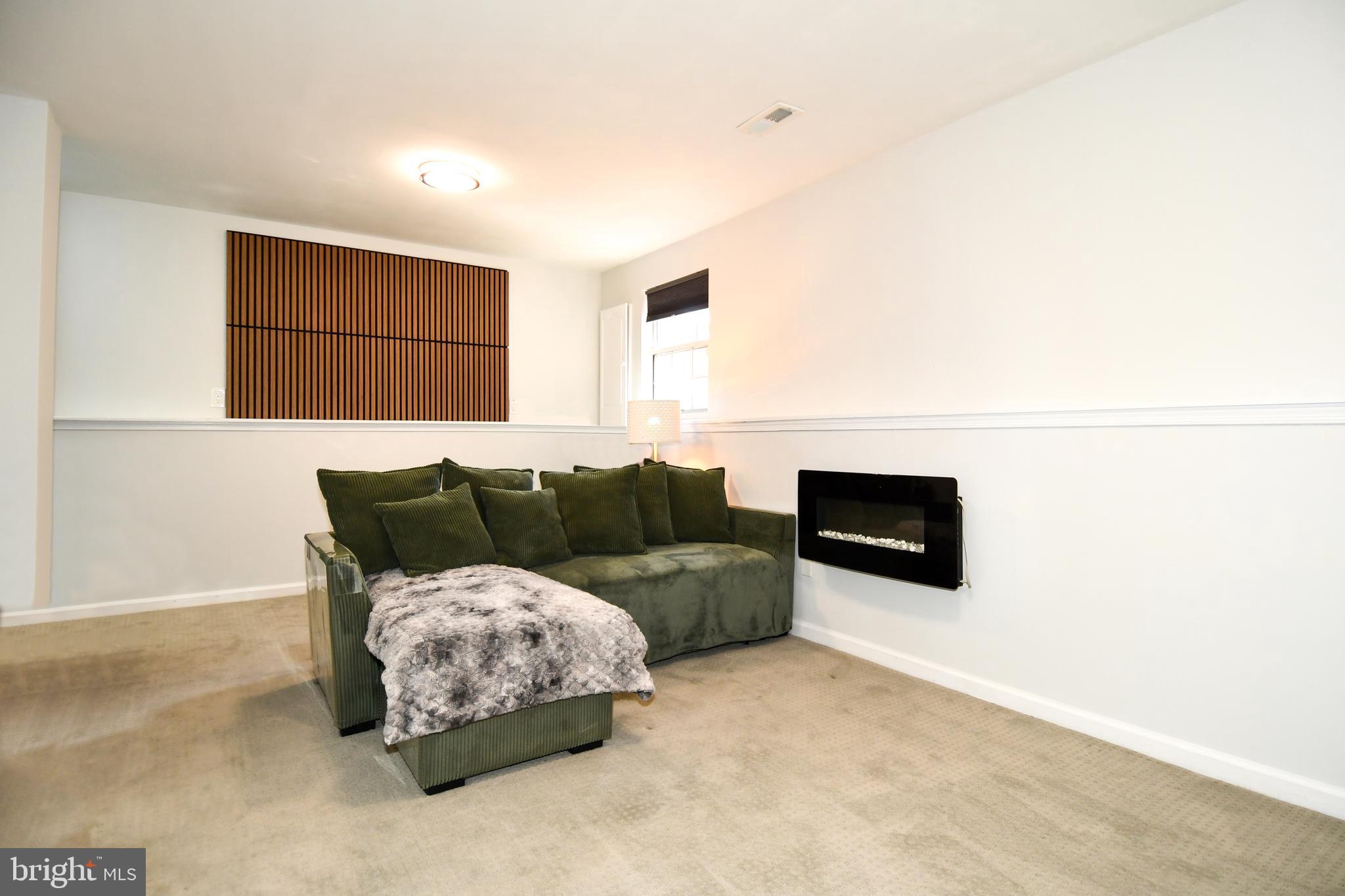 10188 Speedwell Court Manassas, VA 20110 - Photo 42 of 51 a living room with a couch and a flat screen tv
