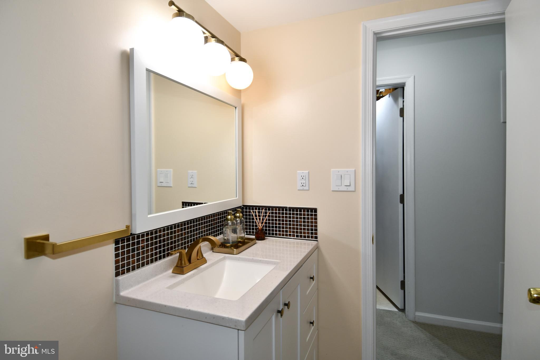 10188 Speedwell Court Manassas, VA 20110 - Photo 45 of 51 a bathroom with a sink and a mirror
