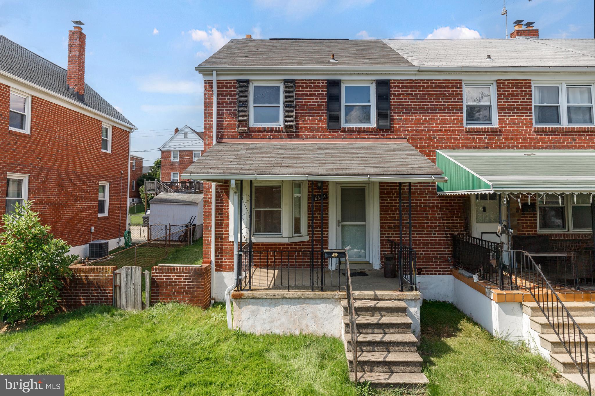 a front view of a house with a yard table and chairs